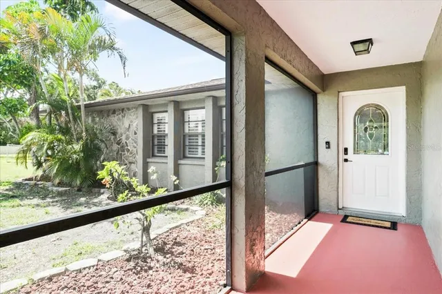 a view of a porch with a floor to ceiling window and wooden floor