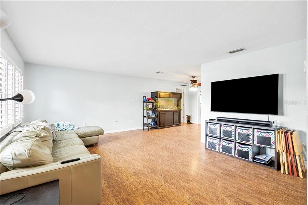 1302 Georgetowne Circle Sarasota, FL 34232 - Photo 5 of 28 a living room with furniture and a flat screen tv