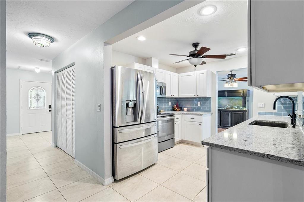 1302 Georgetowne Circle Sarasota, FL 34232 - Photo 10 of 28 a kitchen with granite countertop a sink appliances and cabinets