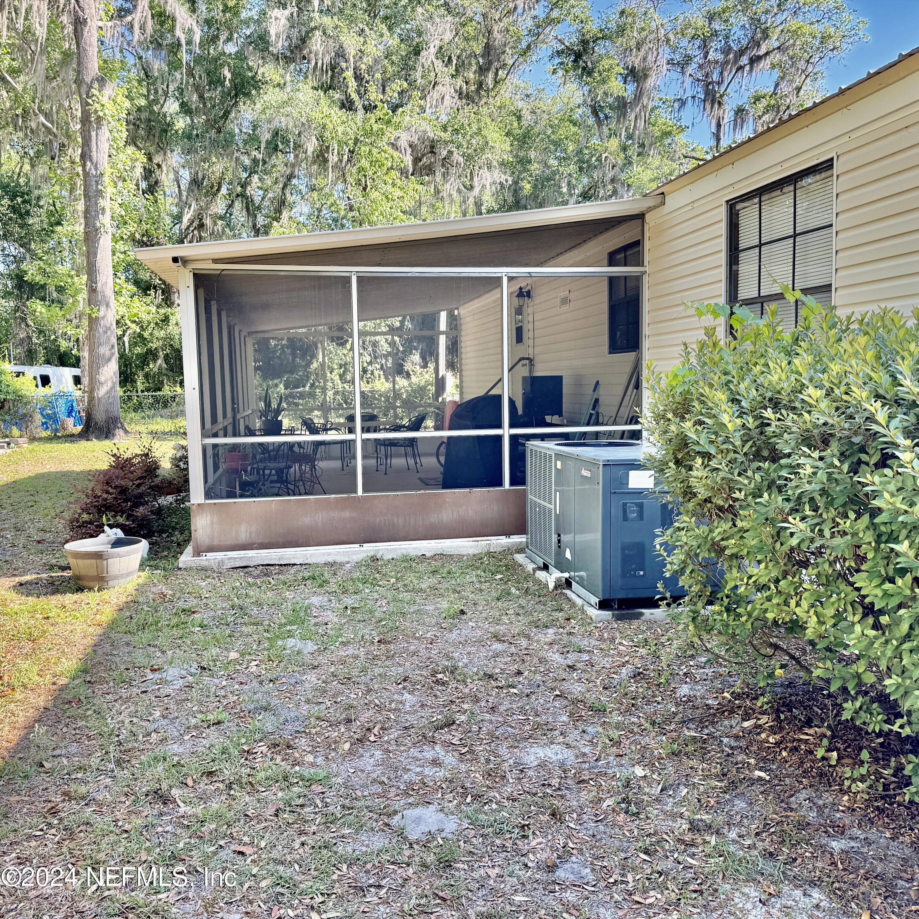 105 George Avenue Interlachen, FL 32148 - Photo 12 of 29 a view of a house with backyard and a garden