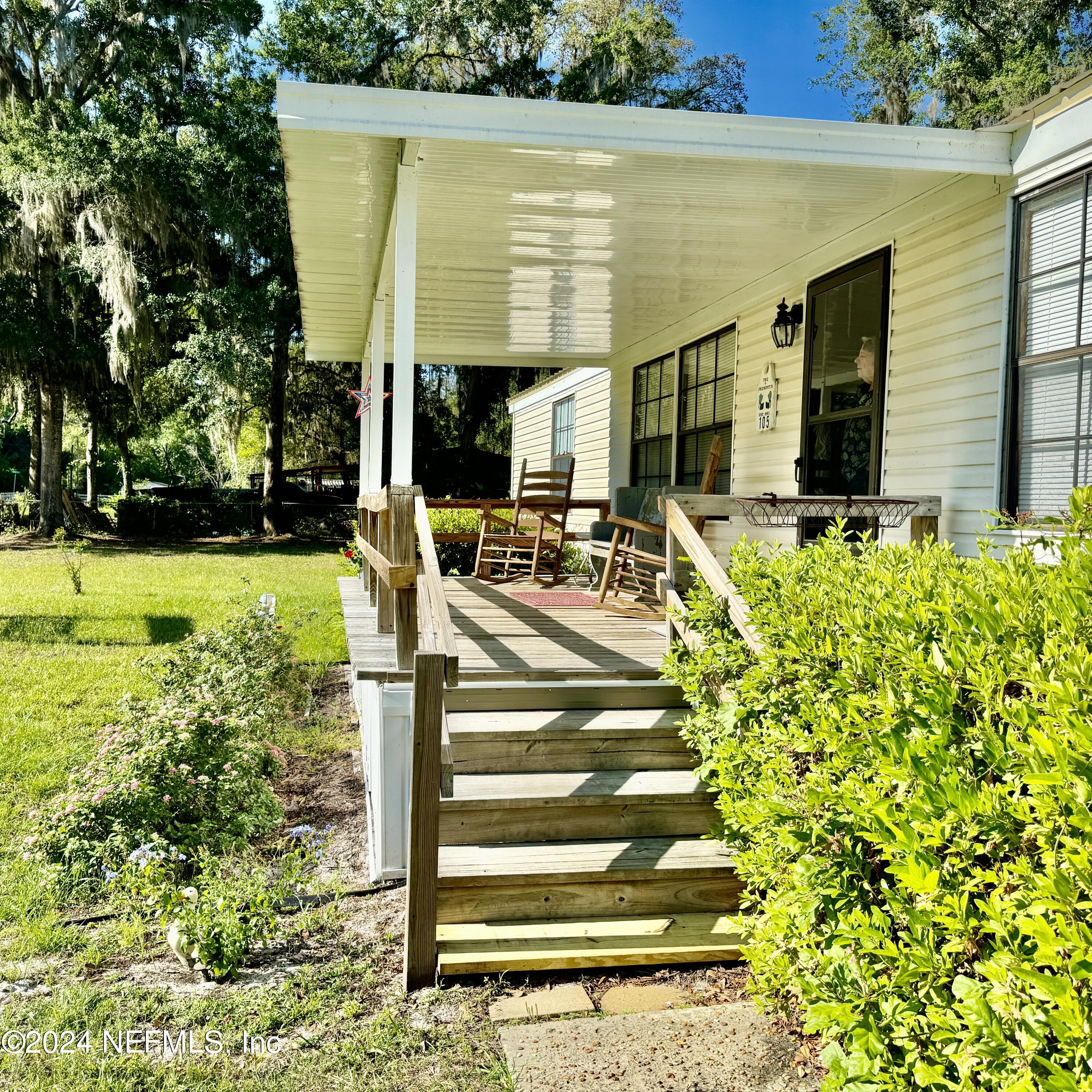 105 George Avenue Interlachen, FL 32148 - Photo 14 of 29 a view of a patio with table and chairs and potted plants