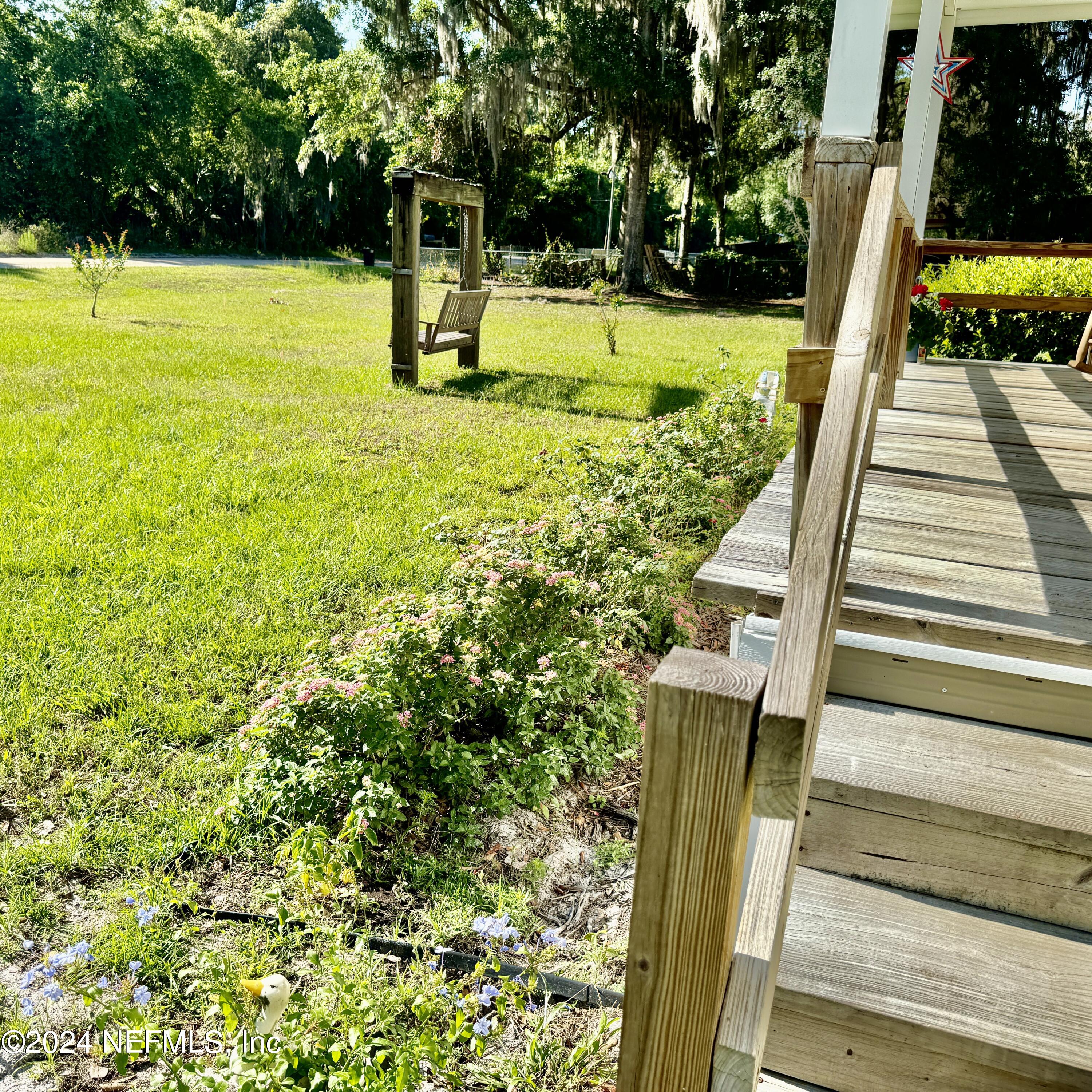 105 George Avenue Interlachen, FL 32148 - Photo 15 of 29 a view of a swimming pool with a garden