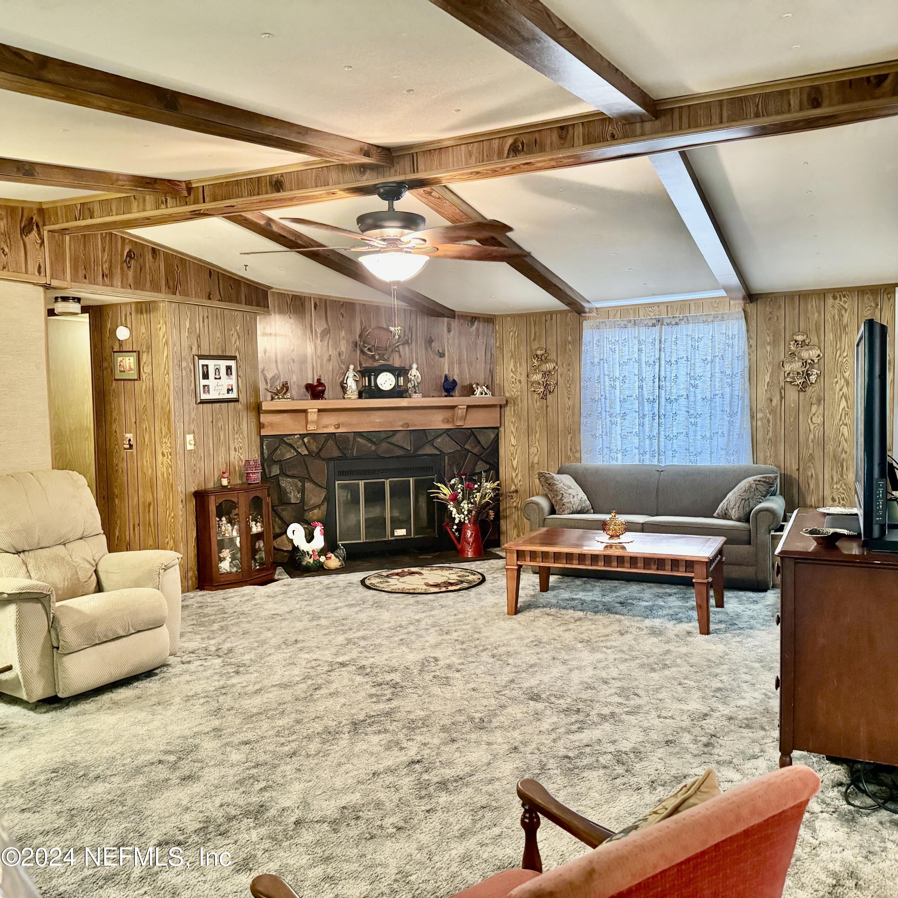 105 George Avenue Interlachen, FL 32148 - Photo 17 of 29 a living room with furniture and a fireplace