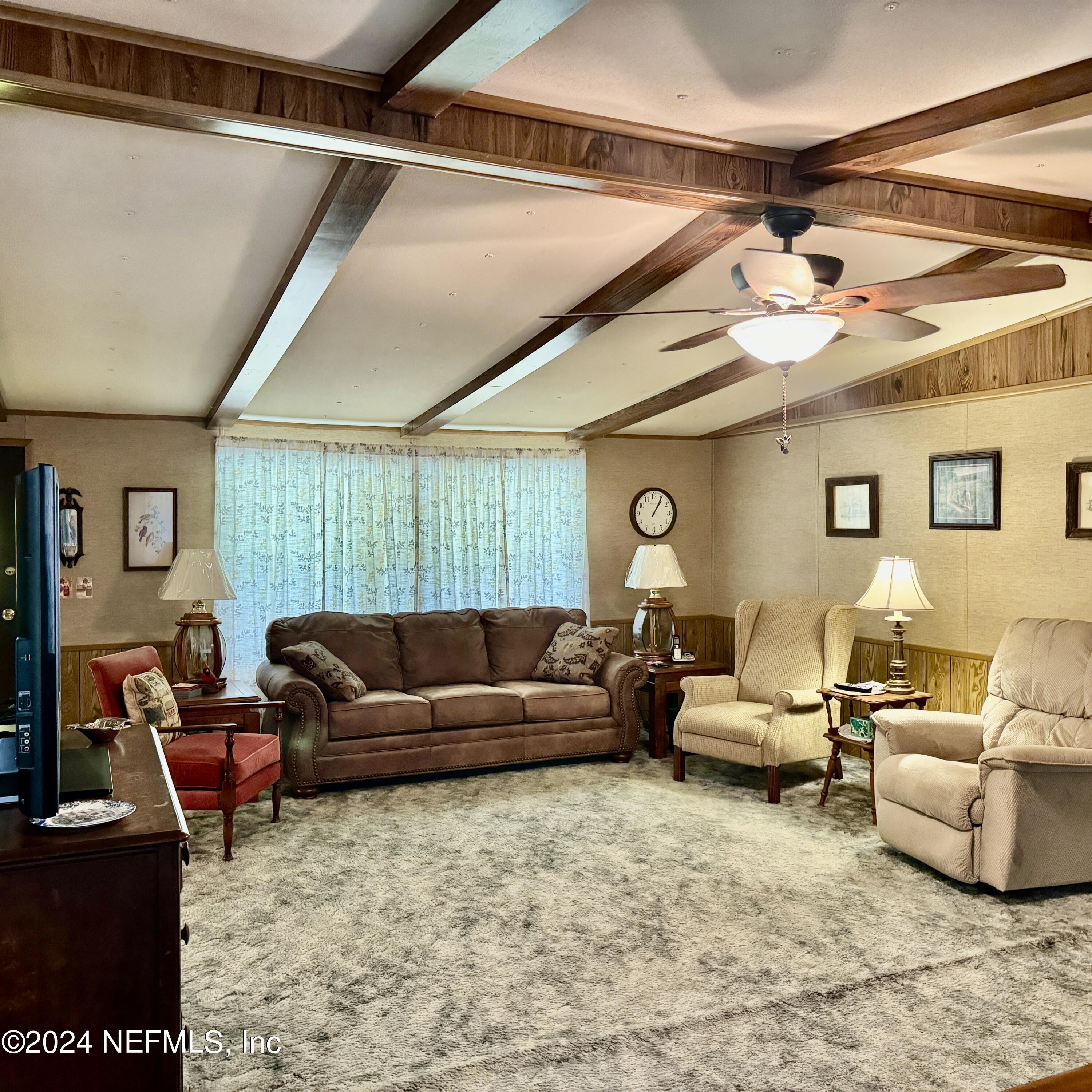 105 George Avenue Interlachen, FL 32148 - Photo 19 of 29 a living room with furniture and a ceiling fan