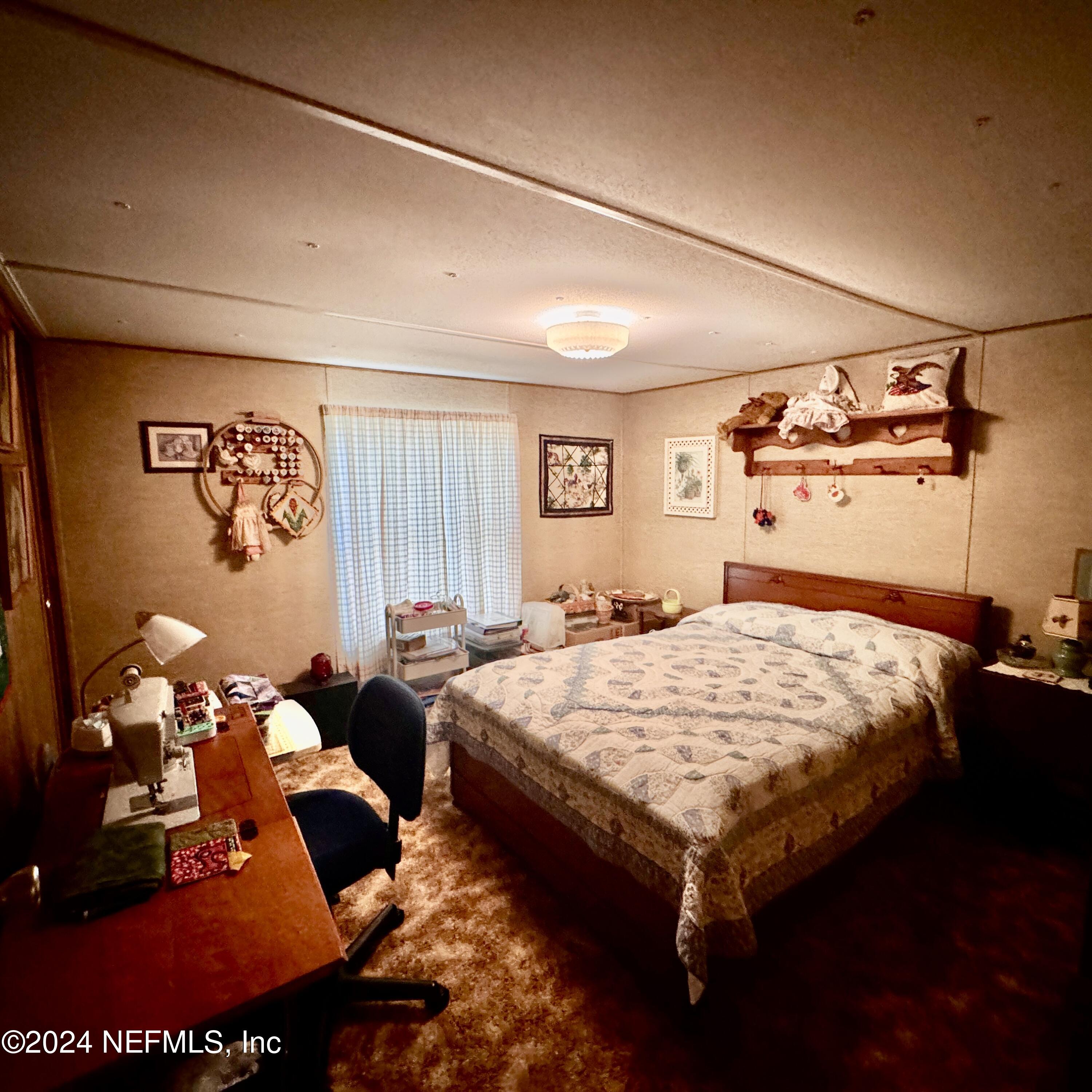 105 George Avenue Interlachen, FL 32148 - Photo 25 of 29 a bed sitting in a bedroom next to a window
