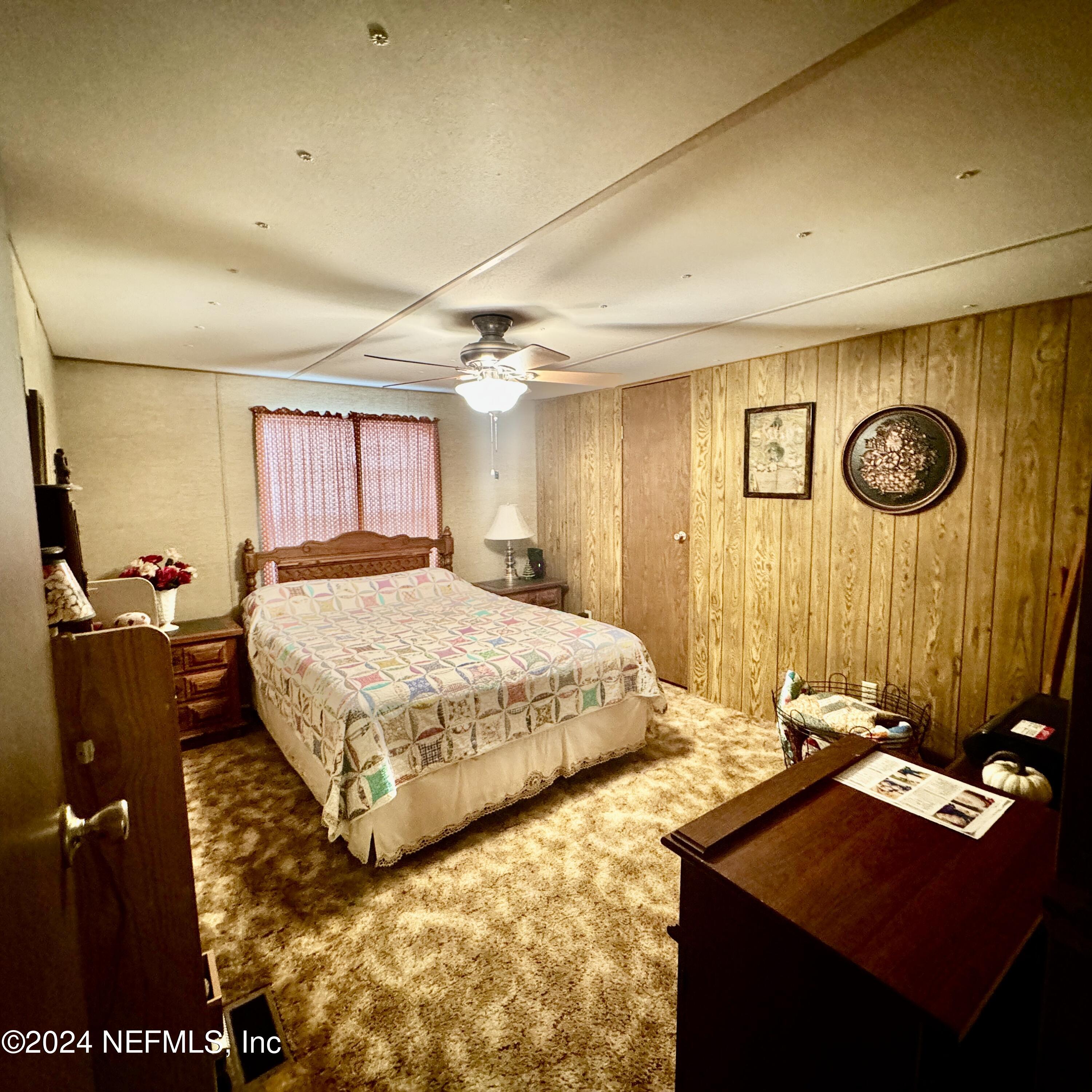 105 George Avenue Interlachen, FL 32148 - Photo 26 of 29 a bedroom with a bed and dresser