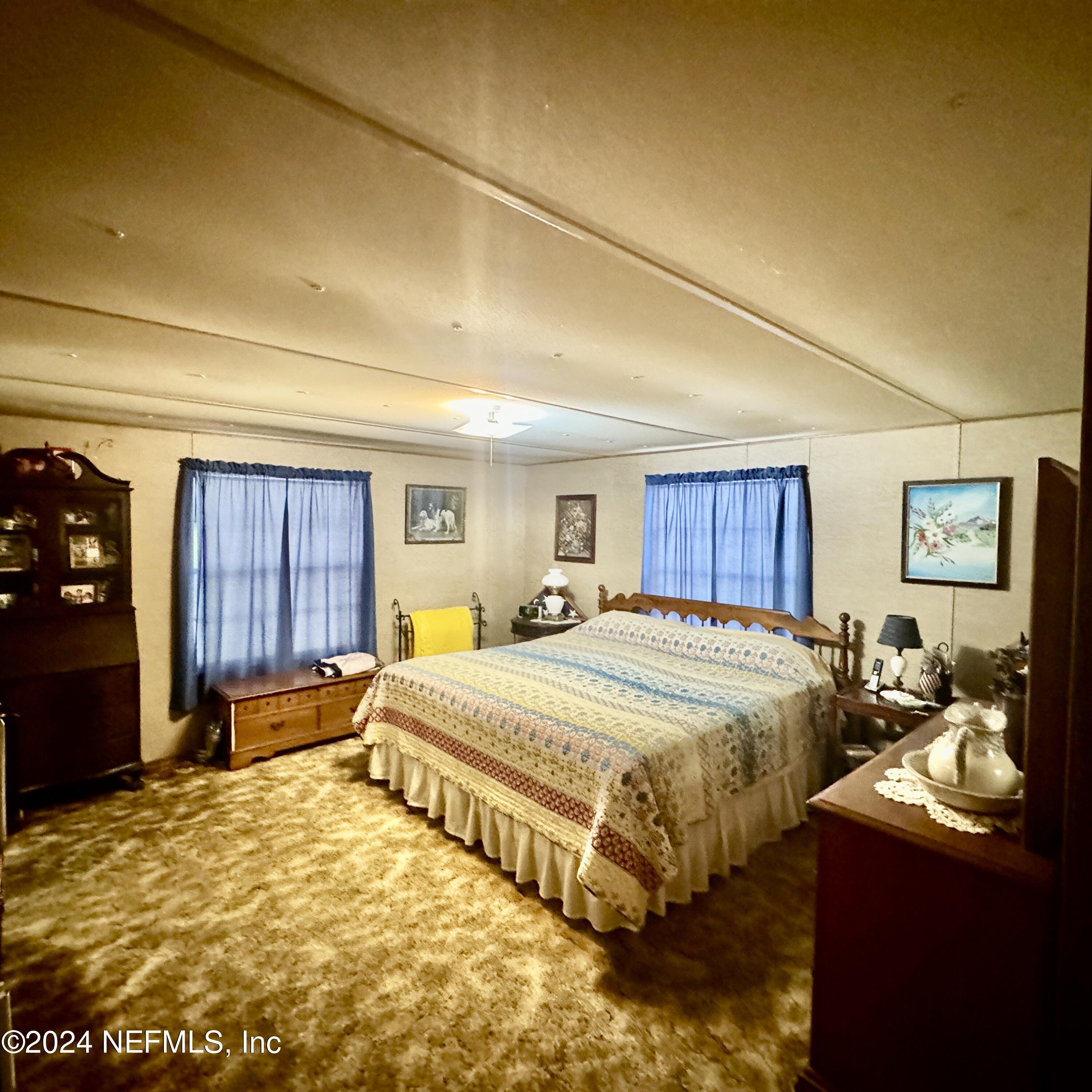105 George Avenue Interlachen, FL 32148 - Photo 28 of 29 a bed room with a bed and dresser