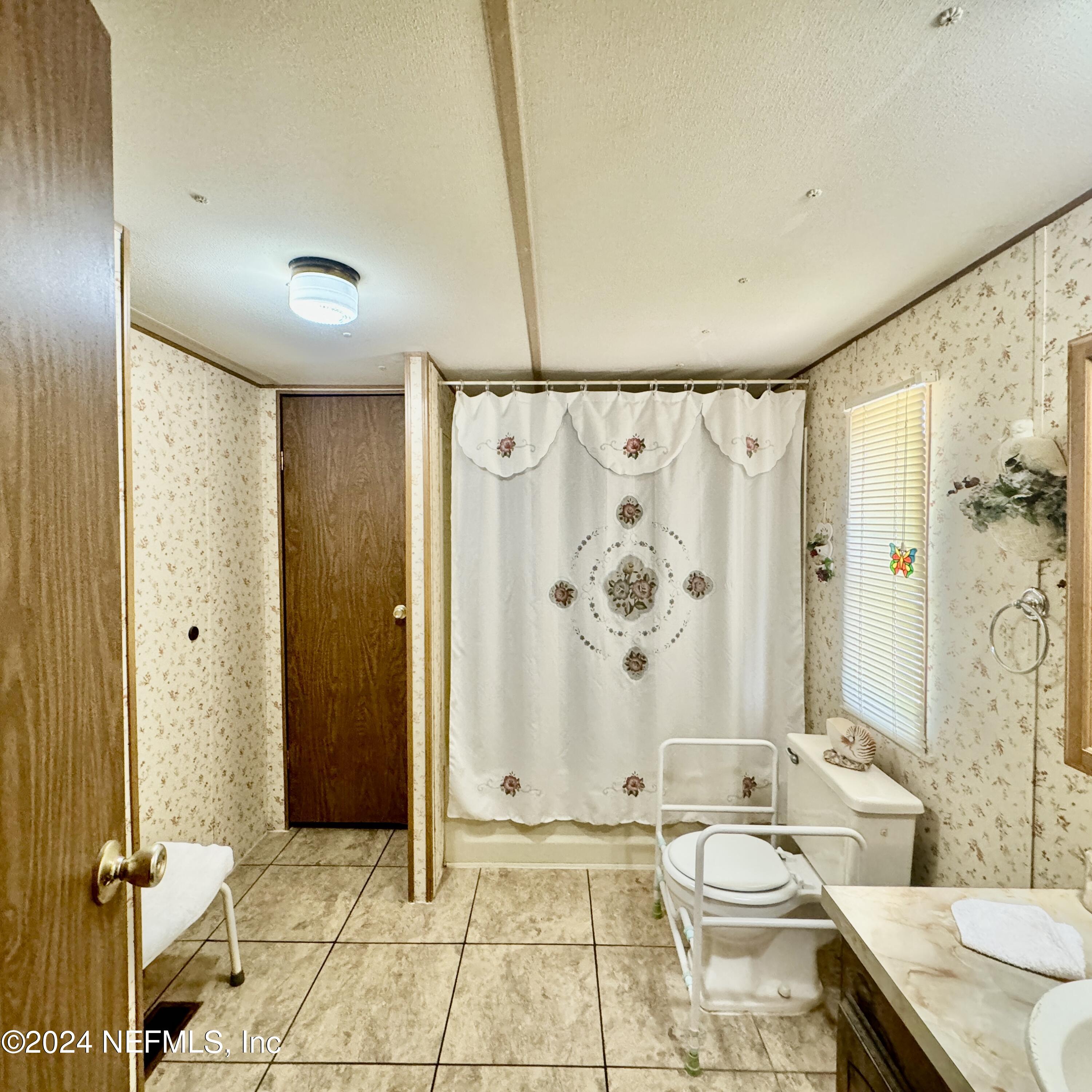 105 George Avenue Interlachen, FL 32148 - Photo 29 of 29 a bathroom with a granite countertop sink a toilet and shower