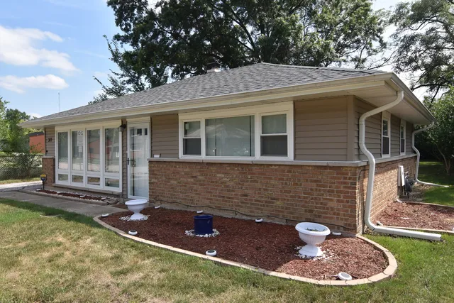 a view of house with backyard space and swimming pool