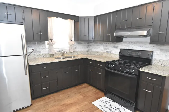 a kitchen with a sink stove and refrigerator