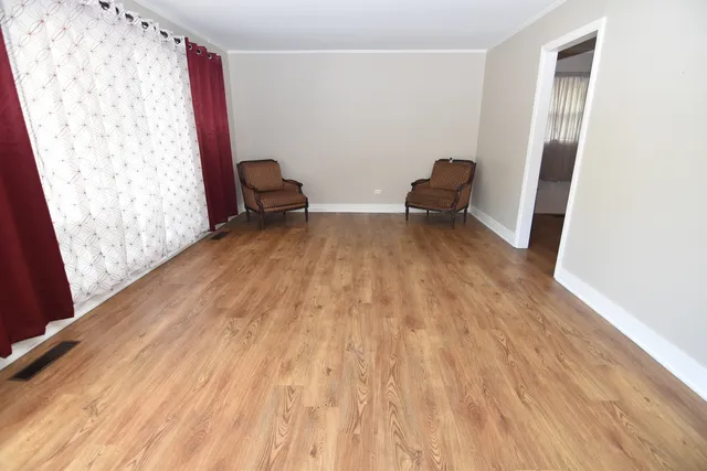 a view of bedroom with wooden floor and furniture