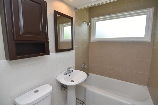a bathroom with a sink a toilet and bathtub