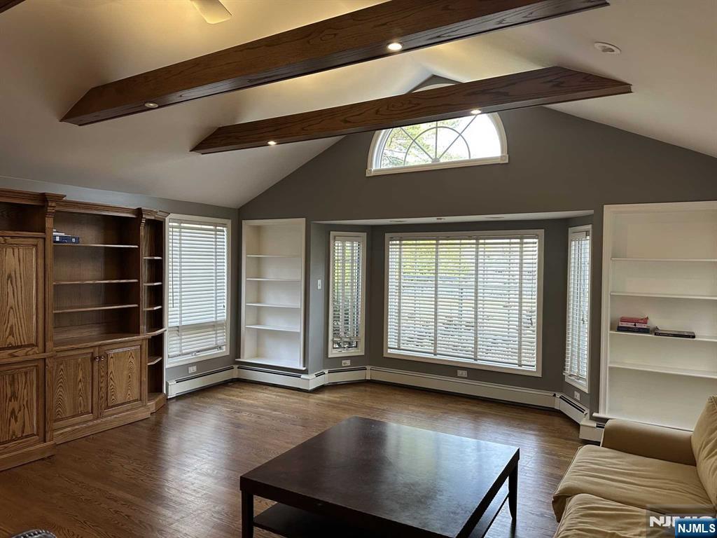 711 Camperdown Road Teaneck, NJ 07666 - Photo 3 of 12 a view of an empty room with a window and wooden floor
