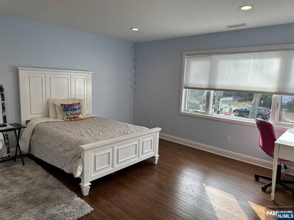 711 Camperdown Road Teaneck, NJ 07666 - Photo 6 of 12 a bedroom with a large bed and a window