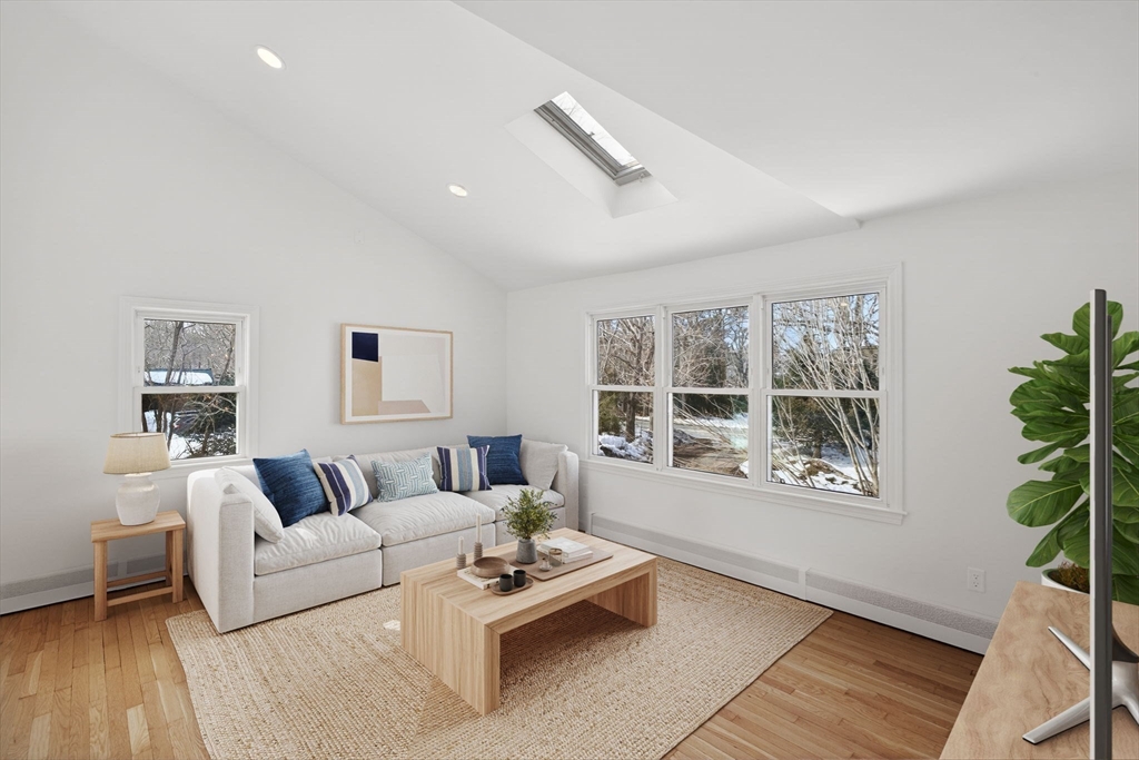585 Old Falmouth Road Barnstable, MA 02648 - Photo 11 of 40 a living room with furniture and a window with wooden floor