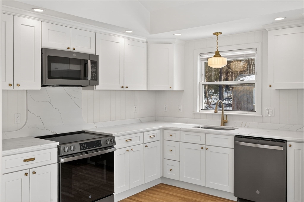 585 Old Falmouth Road Barnstable, MA 02648 - Photo 13 of 40 a kitchen with a sink stove and microwave