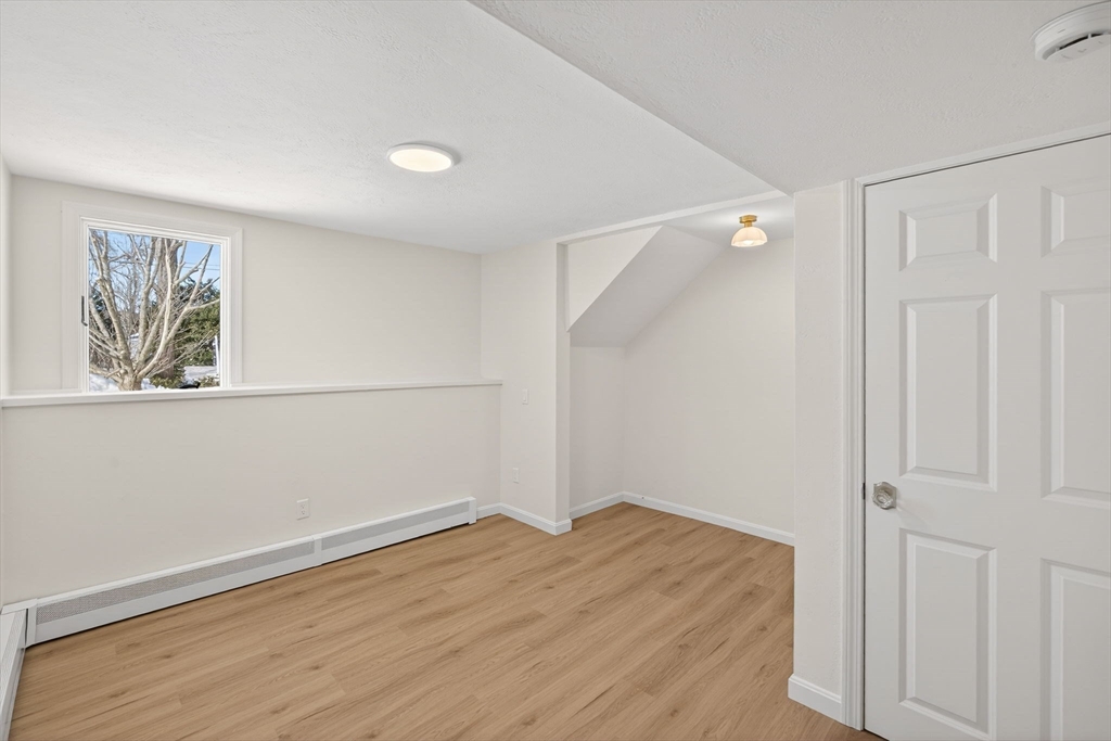 585 Old Falmouth Road Barnstable, MA 02648 - Photo 32 of 40 an empty room with wooden floor and windows