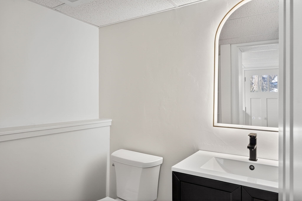 585 Old Falmouth Road Barnstable, MA 02648 - Photo 36 of 40 a bathroom with a sink a toilet and a mirror