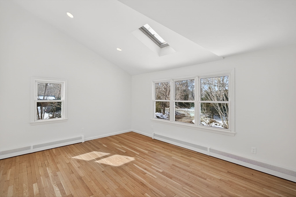 585 Old Falmouth Road Barnstable, MA 02648 - Photo 10 of 40 a view of an empty room with wooden floor and a window