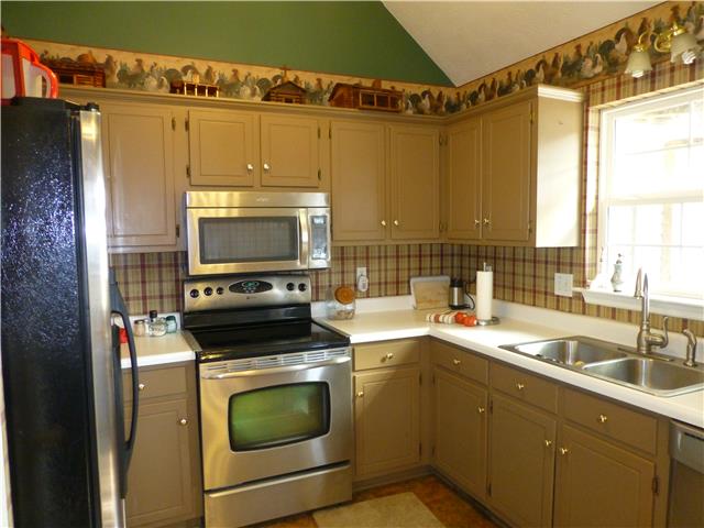 5501 Hunters Point Pike Lebanon, TN 37087 - Photo 7 of 14 Kitchen with vaulted ceiling and stainless steel appliances with window overlooking the rear of the property