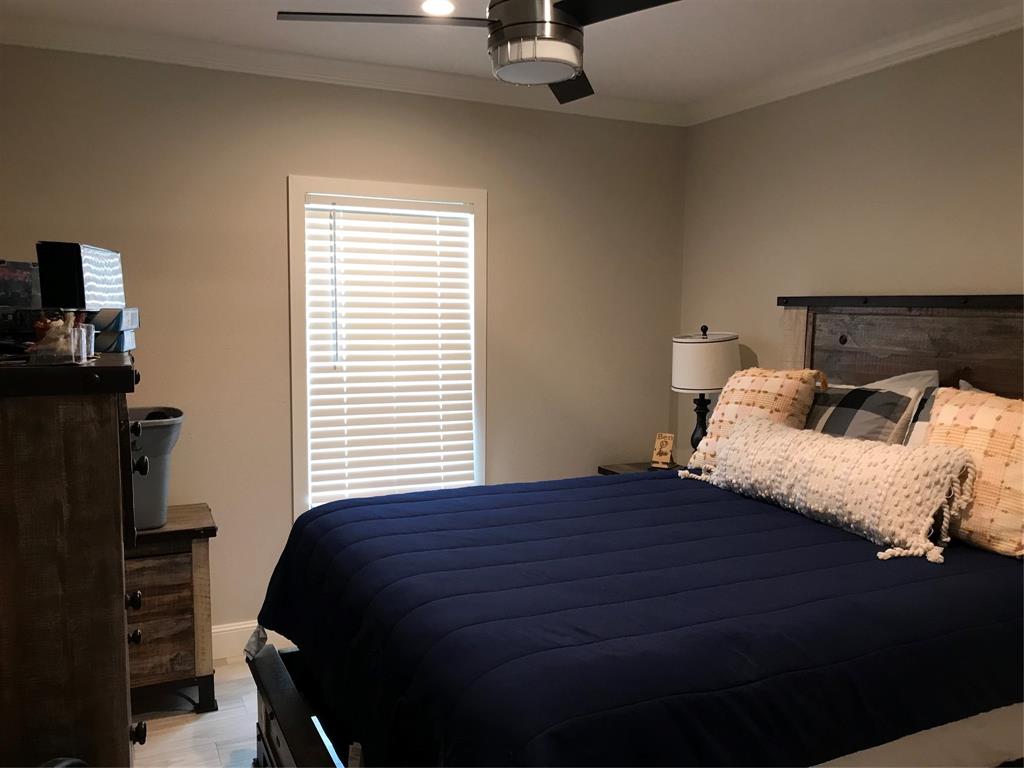 19418 Northwest 246th Street Okeechobee, FL 34972 - Photo 11 of 24 a bedroom with a bed and wooden floor