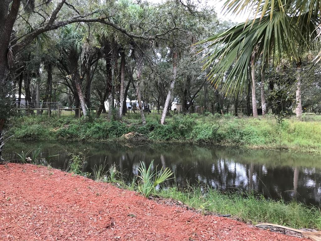 19418 Northwest 246th Street Okeechobee, FL 34972 - Photo 16 of 24 a lake view with a yard