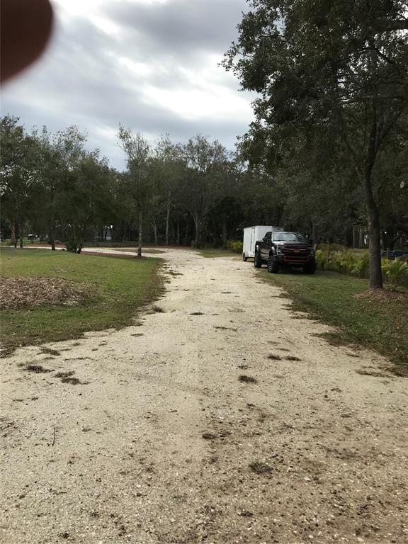 19418 Northwest 246th Street Okeechobee, FL 34972 - Photo 18 of 24 a view of a yard with a car parked
