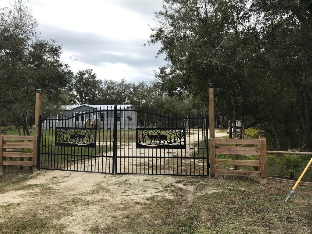 19418 Northwest 246th Street Okeechobee, FL 34972 - Photo 2 of 24 a view of a fence and trees