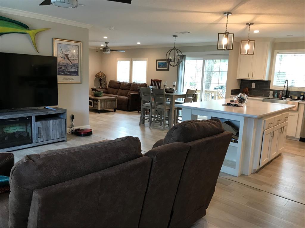 19418 Northwest 246th Street Okeechobee, FL 34972 - Photo 4 of 24 a living room with furniture and a flat screen tv