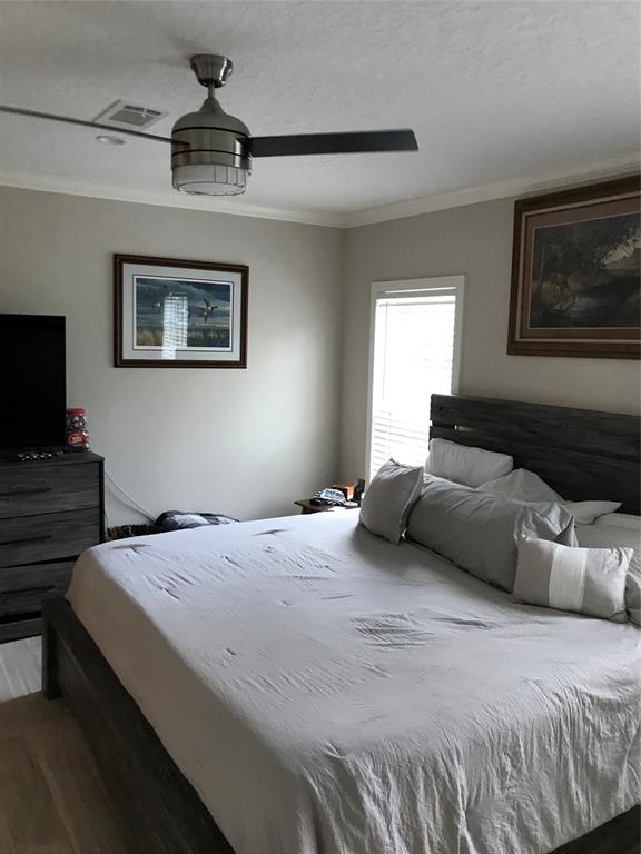 19418 Northwest 246th Street Okeechobee, FL 34972 - Photo 9 of 24 a bedroom with a bed and a flat screen tv