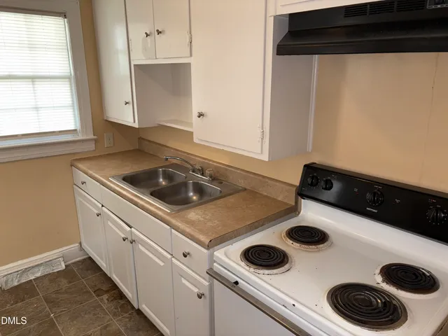 a kitchen with a stove and a microwave
