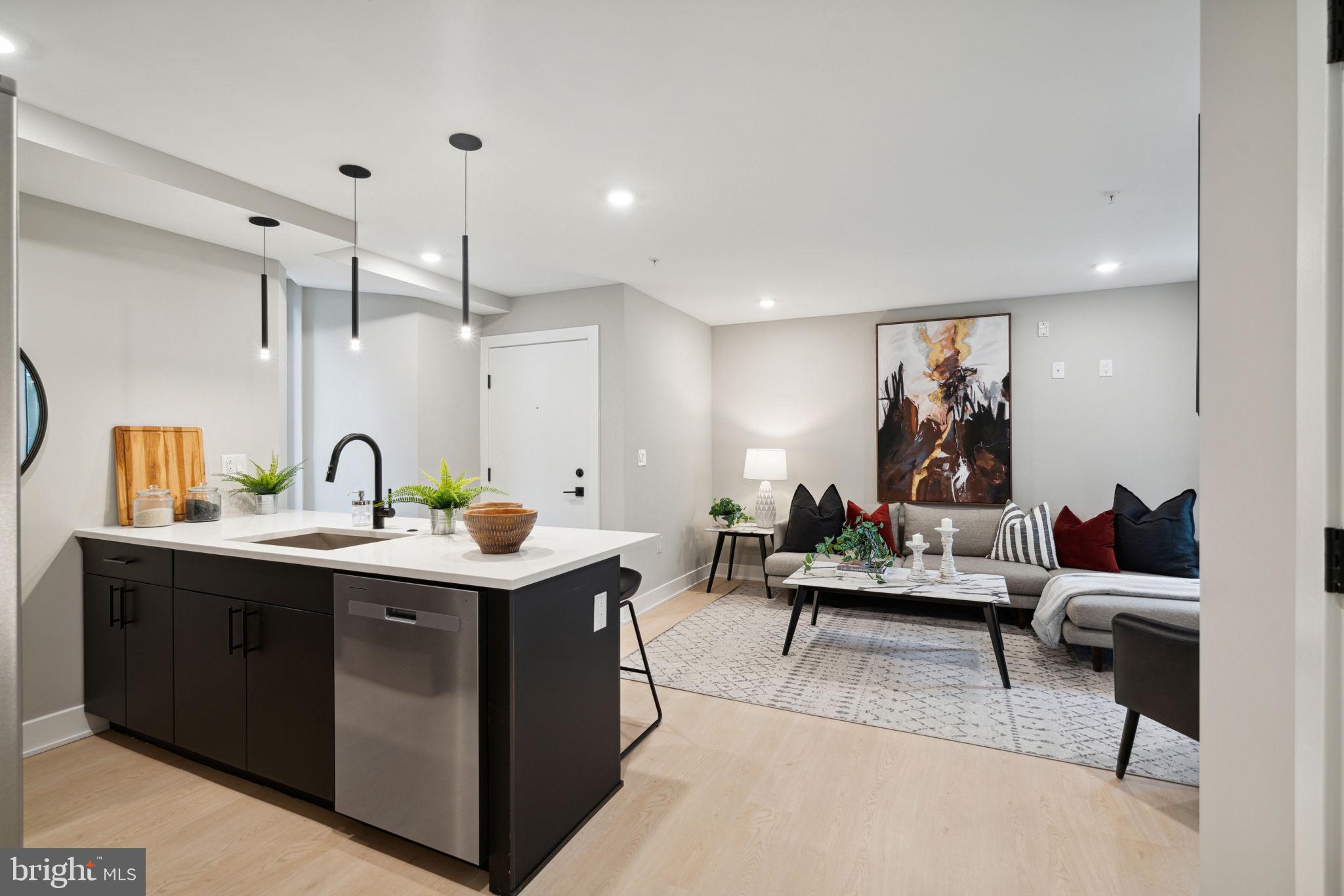 6604 Ridge Avenue, Unit 410 Philadelphia, PA 19128 - Photo 13 of 32 a living room with furniture and a wooden floor