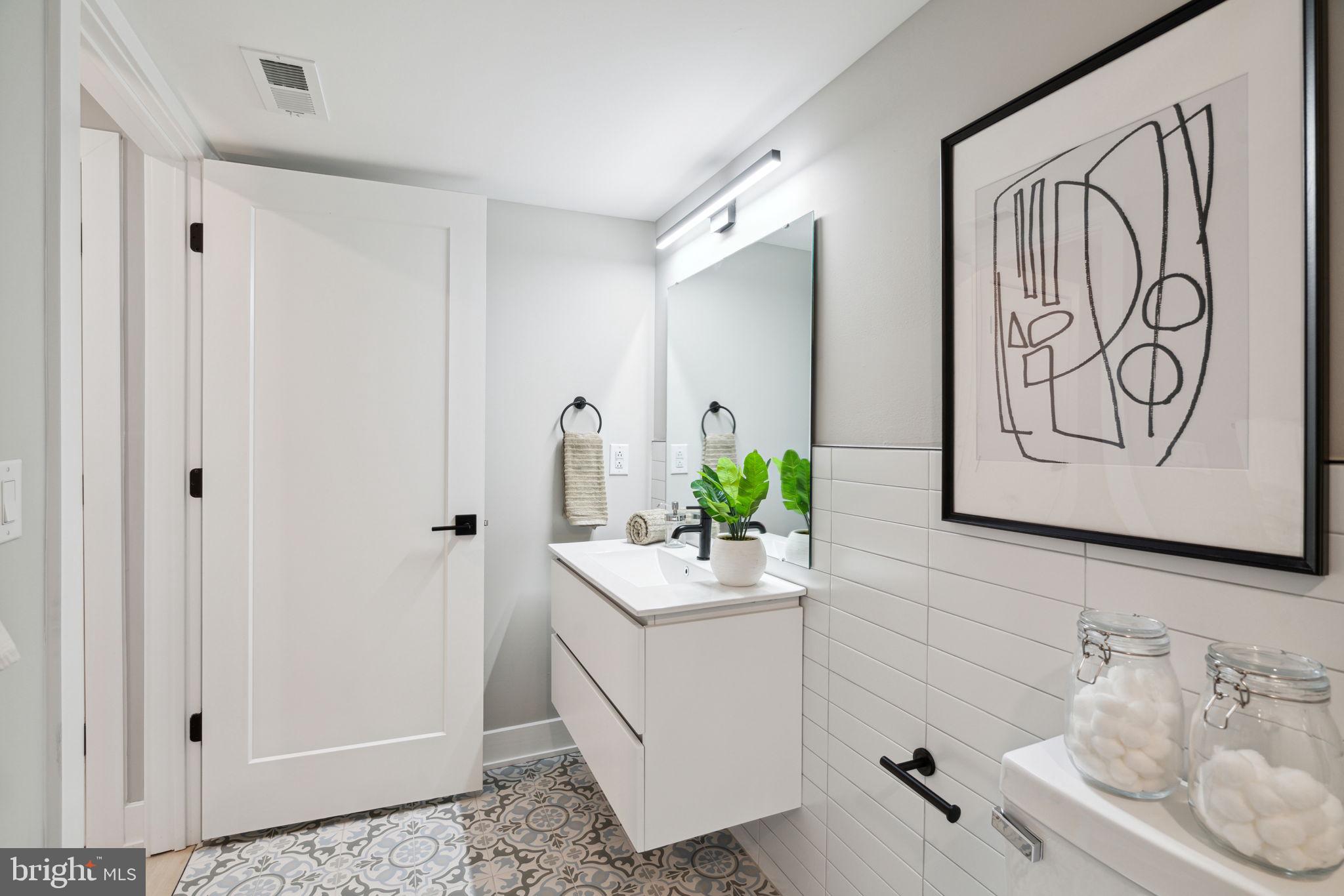 6604 Ridge Avenue, Unit 410 Philadelphia, PA 19128 - Photo 6 of 32 a bathroom with a sink and a mirror