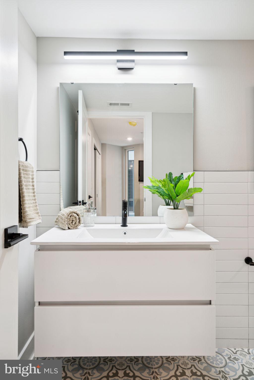 6604 Ridge Avenue, Unit 410 Philadelphia, PA 19128 - Photo 9 of 32 a bathroom with a sink and a mirror