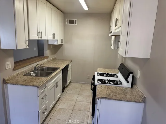 a kitchen with a stove and a sink