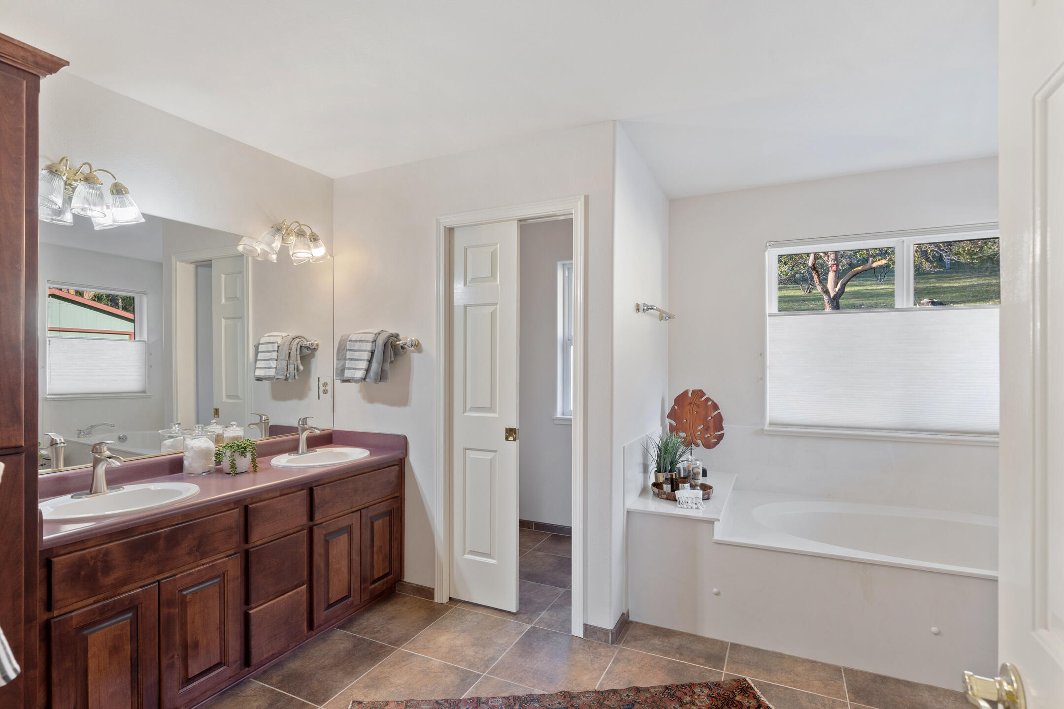1440 Kubli Road Grants Pass, OR 97527 - Photo 19 of 56 a spacious bathroom with a tub sink shower and mirror