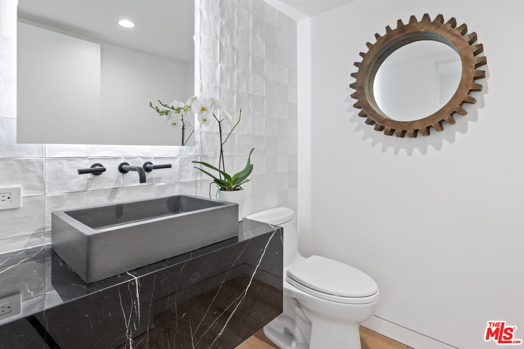 1620 Electric Avenue Venice, CA 90291 - Photo 7 of 24 a bathroom with a sink a mirror and toilet