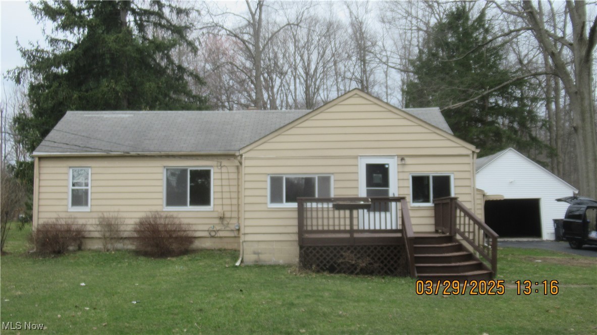 36505 Pettibone Road Solon, OH 44139 - Photo 1 of 24 Rear view of property with a lawn, a detached garage, and a wooden deck