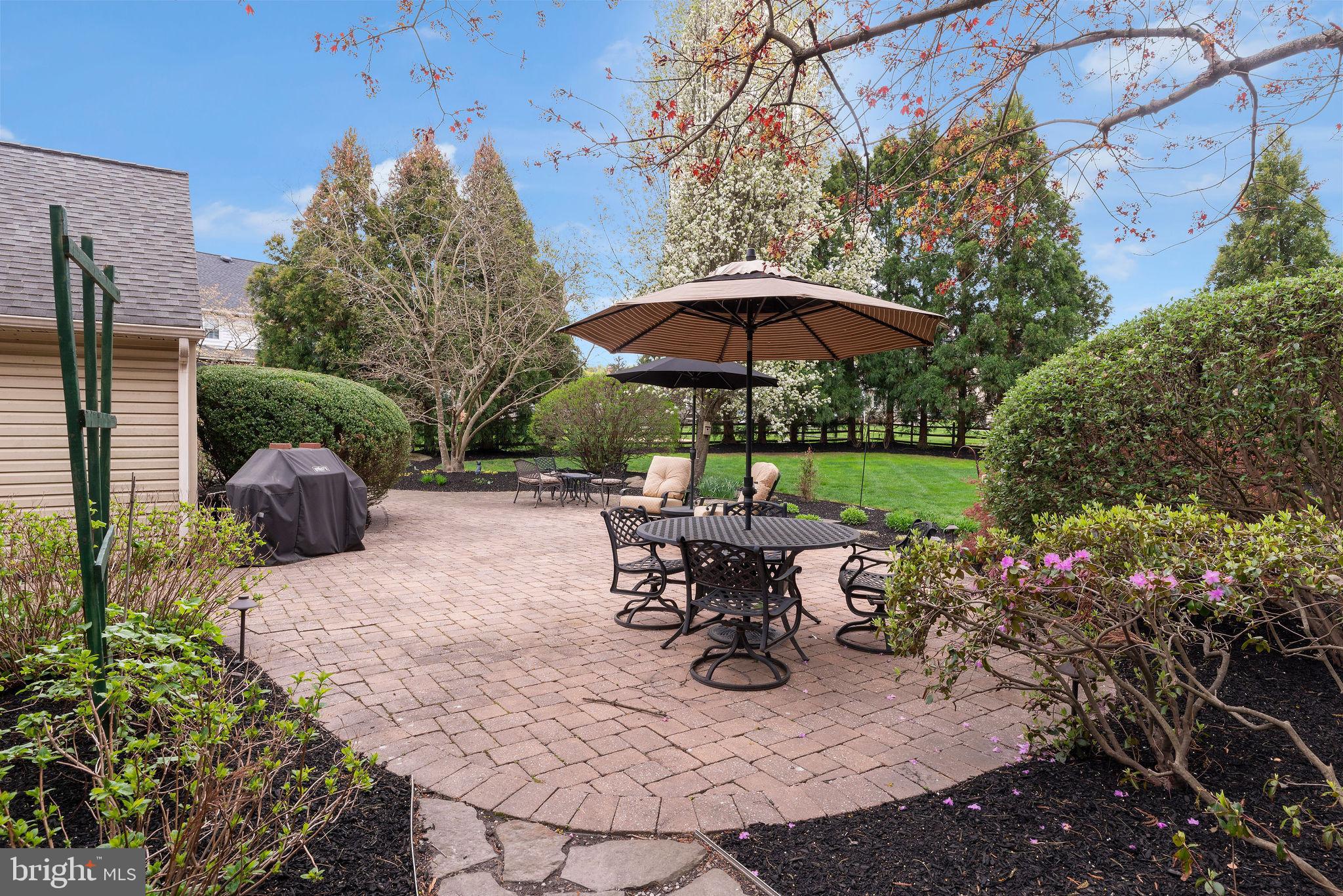 54 John Dyer Way Doylestown, PA 18902 - Photo 46 of 61 a view of a patio with furniture and a table and chairs under an umbrella