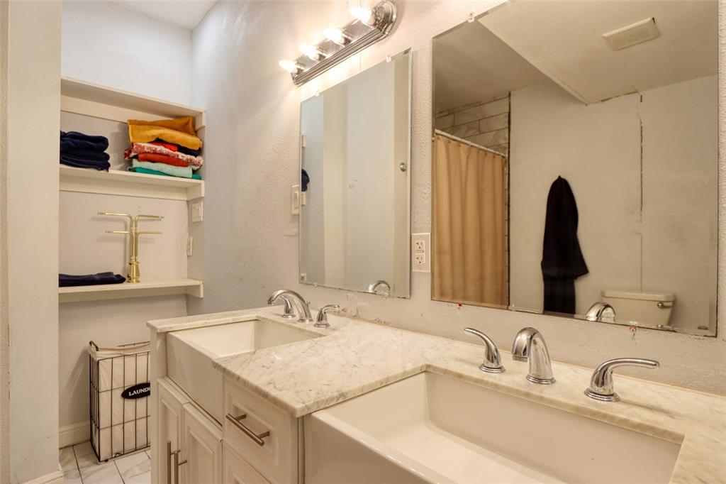 305 East Belt Line Road Wilmer, TX 75172 - Photo 5 of 16 a bathroom with a sink and a mirror