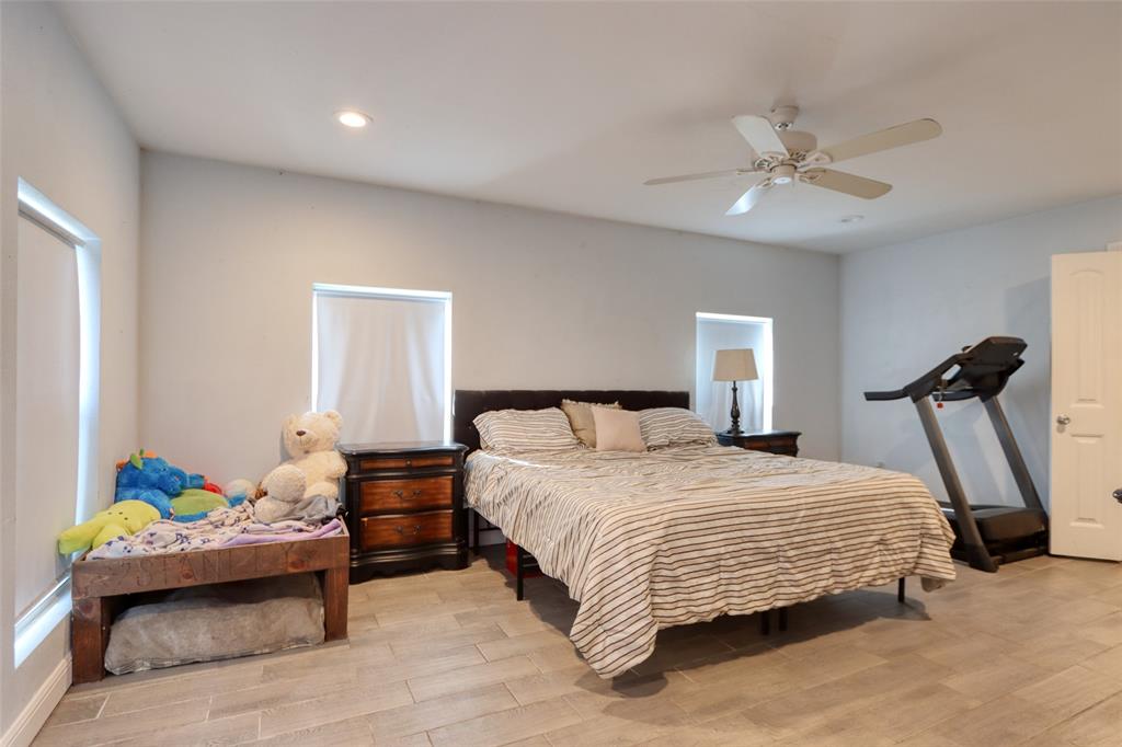305 East Belt Line Road Wilmer, TX 75172 - Photo 8 of 16 a bedroom with a bed and ceiling fan