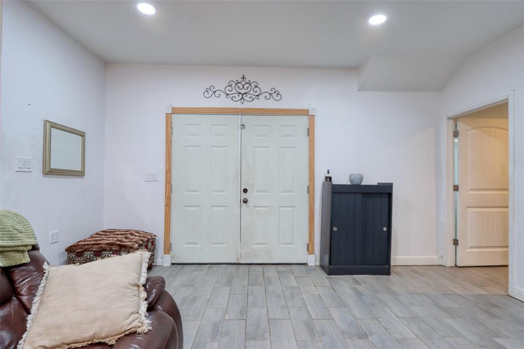 305 East Belt Line Road Wilmer, TX 75172 - Photo 10 of 16 a bedroom with a bed and a cabinets