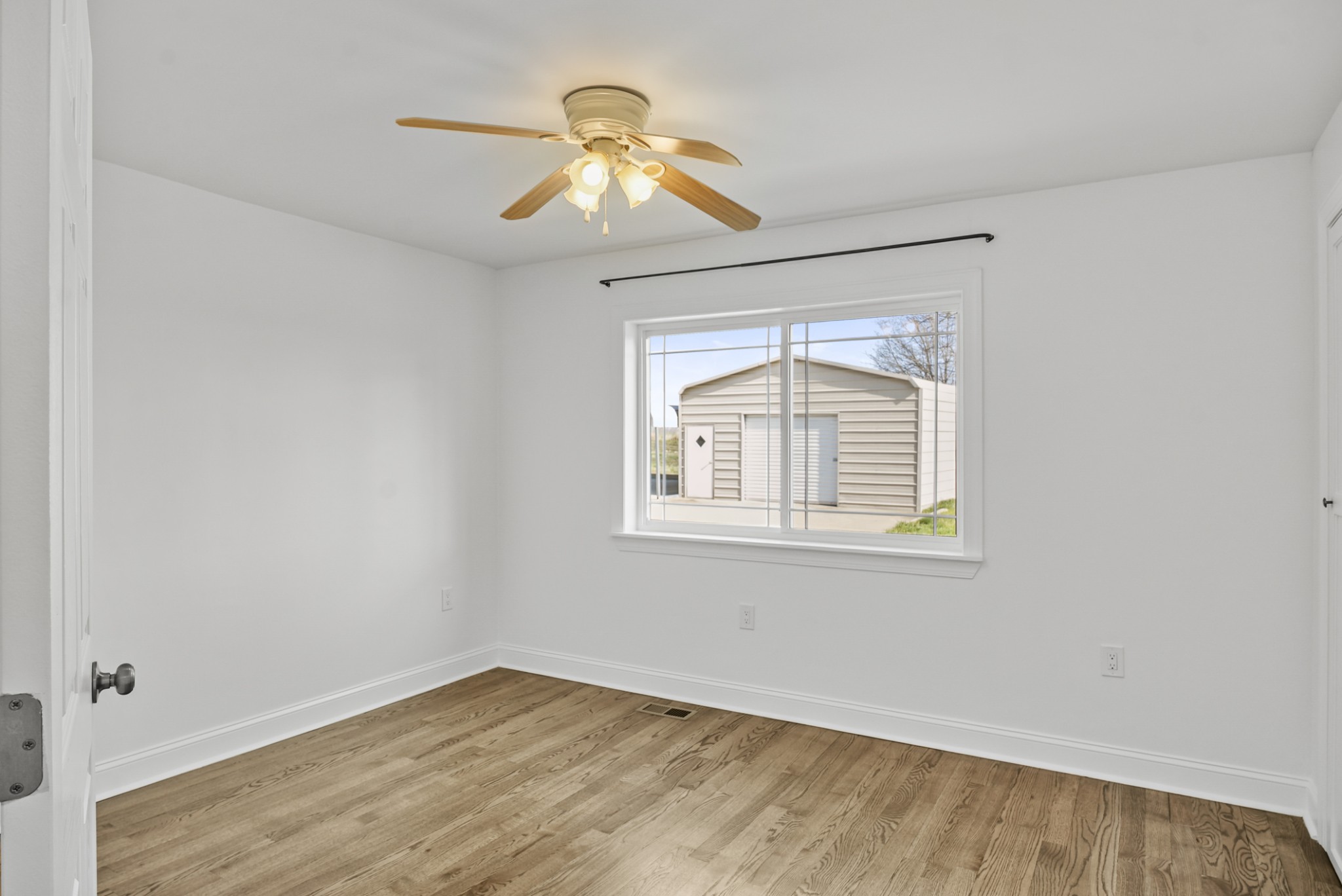 20 Zinker Road Lawrenceburg, TN 38464 - Photo 18 of 39 an empty room with wooden floor chandelier and windows