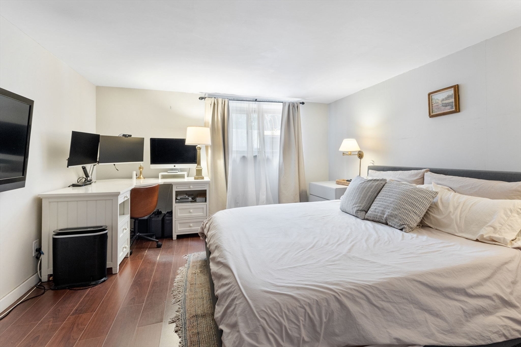 116 Sutherland Road, Unit 1A Boston, MA 02135 - Photo 12 of 21 a bedroom with a bed and a flat screen tv