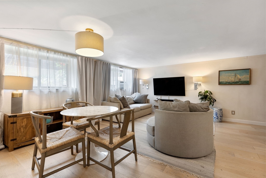 116 Sutherland Road, Unit 1A Boston, MA 02135 - Photo 4 of 21 a living room with furniture a flat screen tv and a lamp