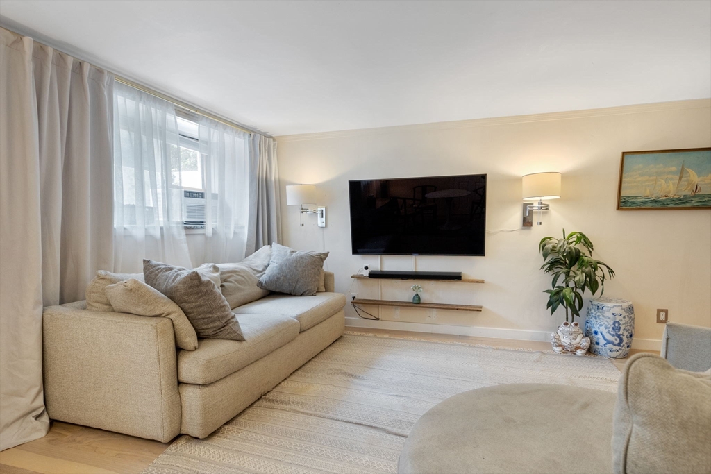 116 Sutherland Road, Unit 1A Boston, MA 02135 - Photo 7 of 21 a living room with furniture and a flat screen tv