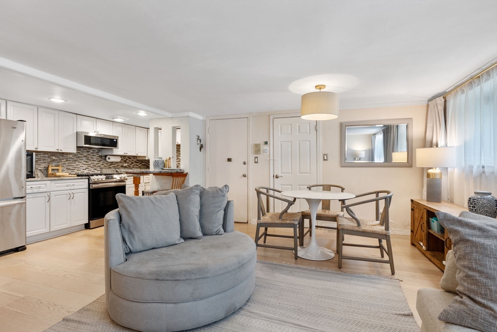 116 Sutherland Road, Unit 1A Boston, MA 02135 - Photo 8 of 21 a living room with furniture and kitchen view