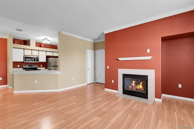 a view of an empty room with fire place and a fireplace