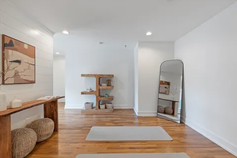 a living room with furniture and a wooden floor