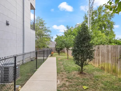 a view of a pathway with a wrought fence
